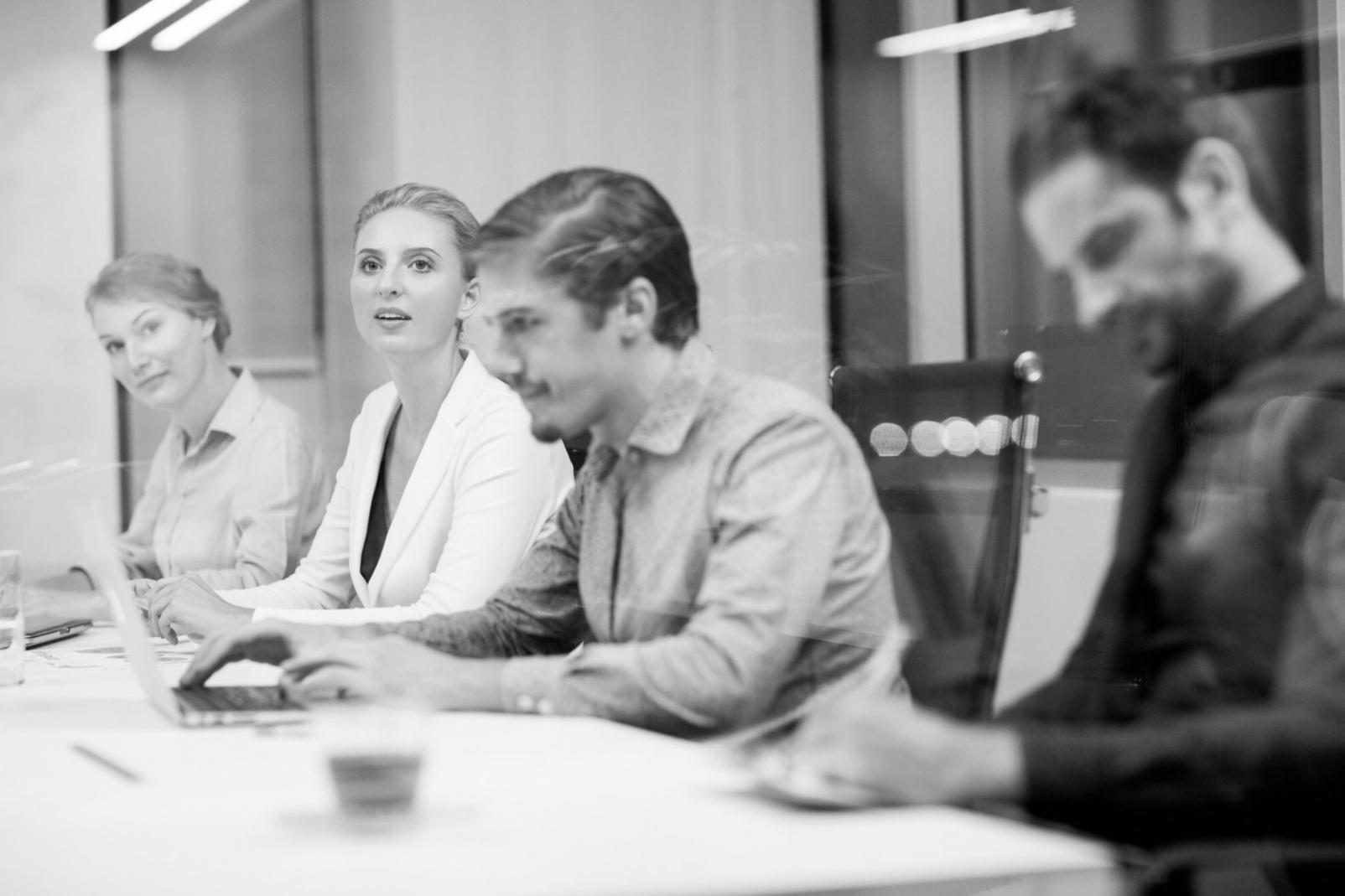 Modern collaborative workspace with financial analysis tools and team consultation area